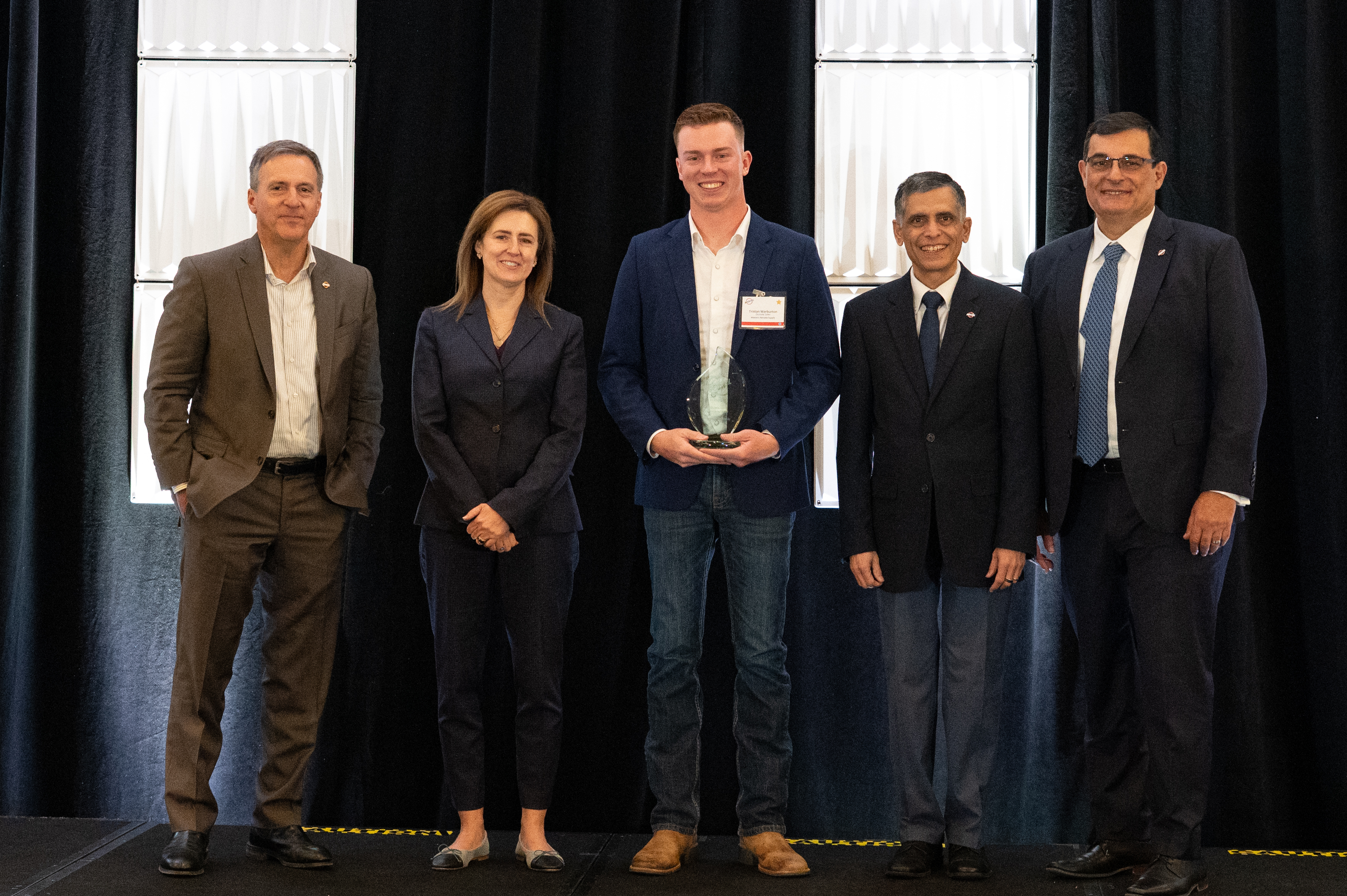 On behalf of Western Nevada Supply, Tristan Warburton (center) accepts one of Bechtel Corporation’s 2025 Global Supply Chain Awards
