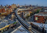 A CTA Brown line train traveling on the new Red-Purple Bypass at the Belmont Station crossing. The elevated bypass eliminates track conflicts and improves throughput for Red, Purple and Brown Line service. Note the Chicago skyline in the background.